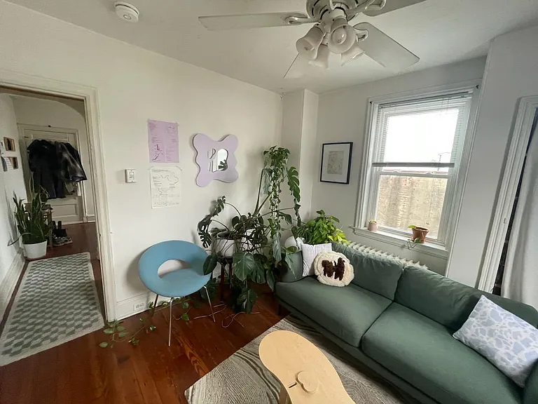 Photo from 2024 with the back room ( which has the deck off of it) being used as a living room/office. Photos from 2021 show this room as a bedroom