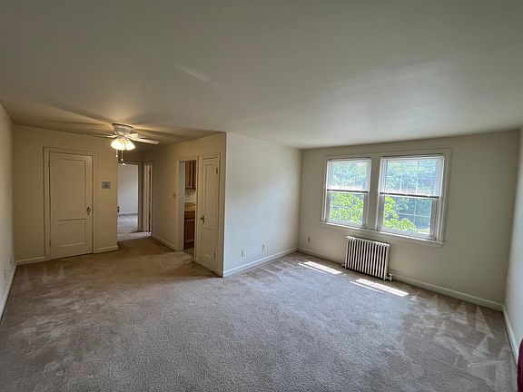 From living room w/2 double pane vinyl windows, radiator, ceiling fan & light, & entrance to Kitchen, Bathroom, and Bedroom.
