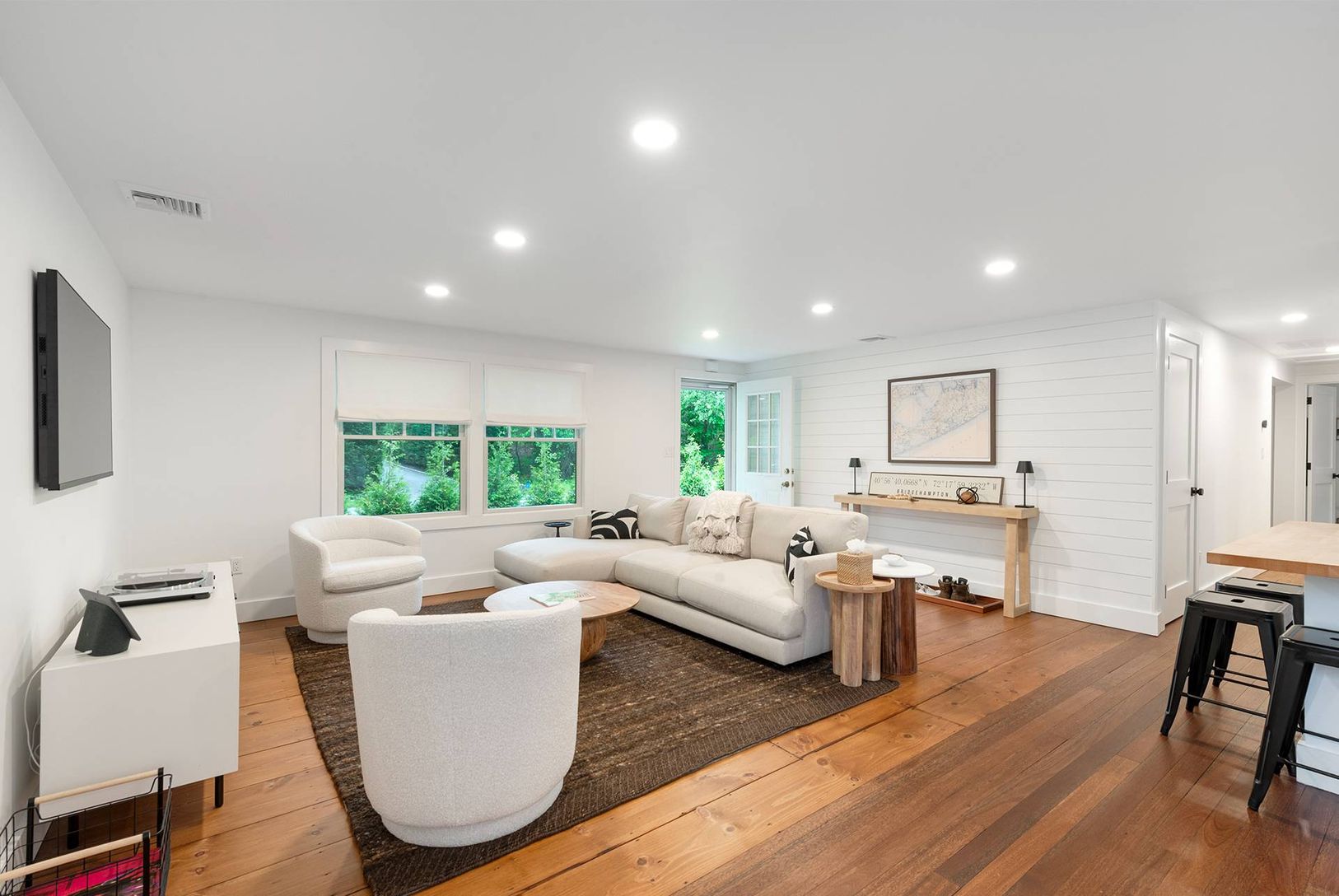  Cozy living room furnished from West Elm. Includes SmartTV, record player, and lots of light.