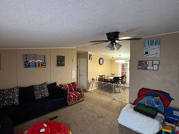 Walking in the front door to living room and dining room kitchen area