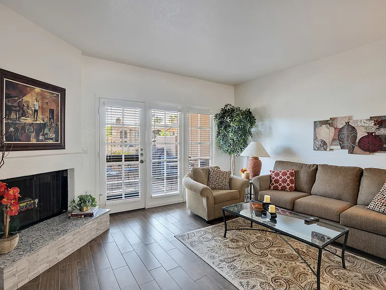Living room with fireplace and french doors to patio.