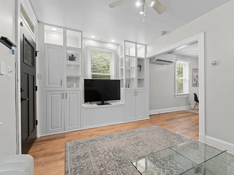 Built-in custom cabinetry in living room surrounded by lots of windows & natural light!