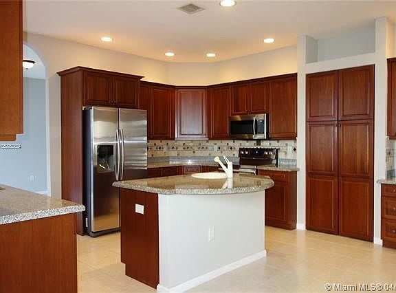 Spacious chefs kitchen freshly painted with new stainless steel appliances and butlers pantry