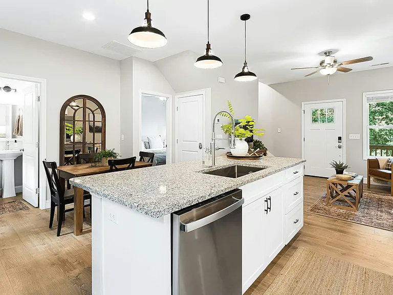Open kitchen with granite counters offering several prep areas, and ample seating for the whole crew