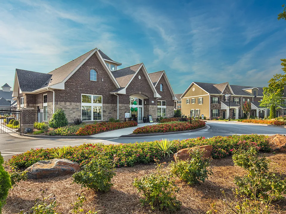 Lush landscaping and modern design create the perfect first impression.