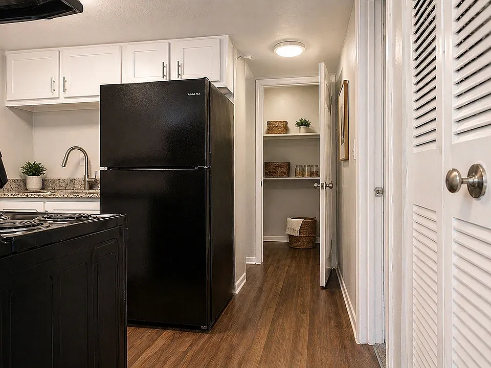 Fully equipped kitchen with granite counters, black appliances & modern cabinetry