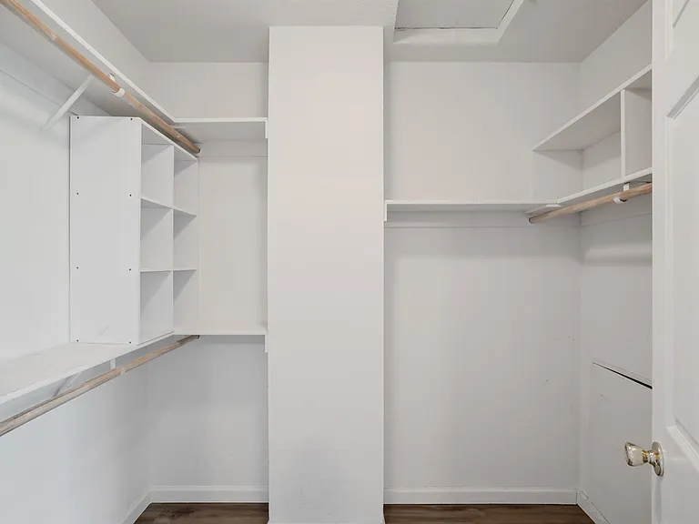 The view of the master bedroom walkin closet.