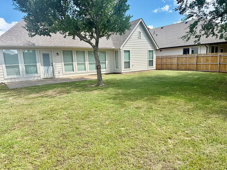 Backyard and patio with shade trees