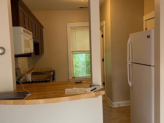 View of kitchen from family room. Counter is perfect for 1-2 kitchen stools.
