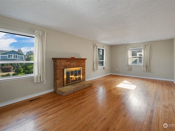 Wood burning fireplace provides ambiance while keeping you toasty on those cold PNW winters.>