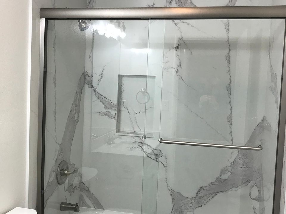 Enclosed tub/shower with quartz siding to the ceiling
