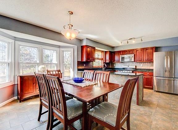 Eat in Kitchen with lots of natural light/windows. Ceramic Tile Flooring, freshly painted kitchen and updated stain on cabinets. Stainless Steel refrigerator stays.