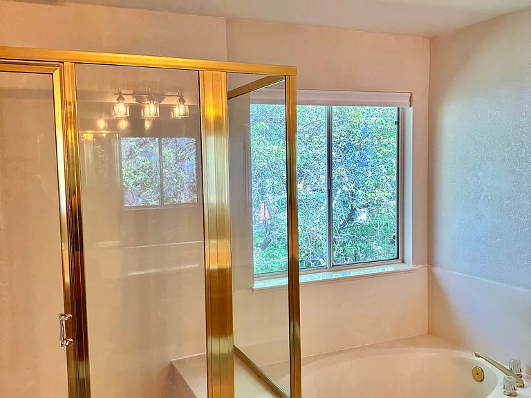 Ensuite bathroom with shower and bathtub