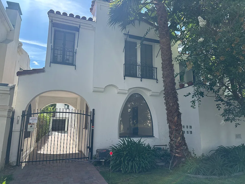 Front view, large living room window, gated back courtyard, with garage space
