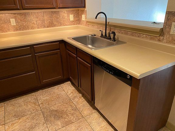 Lots of cabinet space, tile floor, disposal in sink, and dishwasher