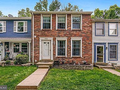 THREE-LEVEL BRICK TOWNHOME BACK TO TREES!