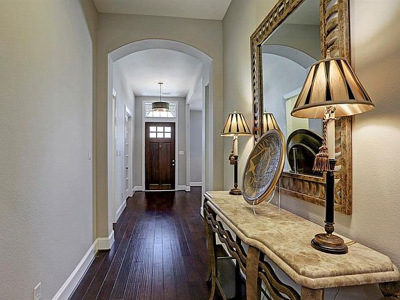 Stunning front door with windows for natural light and a transom window! Rich hard wood floors in the foyer.