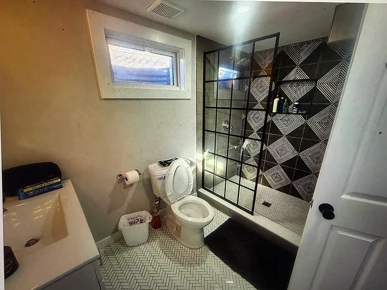Resort-inspired luxury awaits in this beautifully renovated bathroom, featuring a custom walk-in glass shower, designer tile, and premium finishes that create the perfect spa-like retreat.