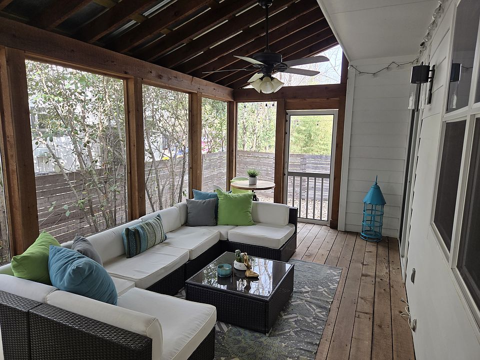 Cozy screened porch with ceiling fan connects the 1 car garage to the living room