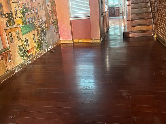 Living space with exposed brick and hand painted mural