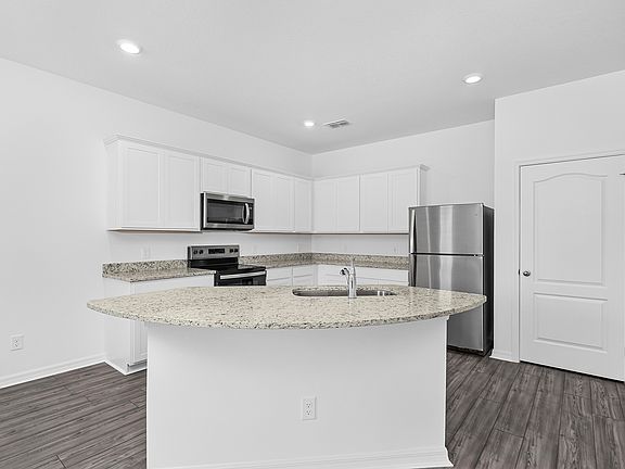 The kitchen is chef-ready with stainless steel appliances