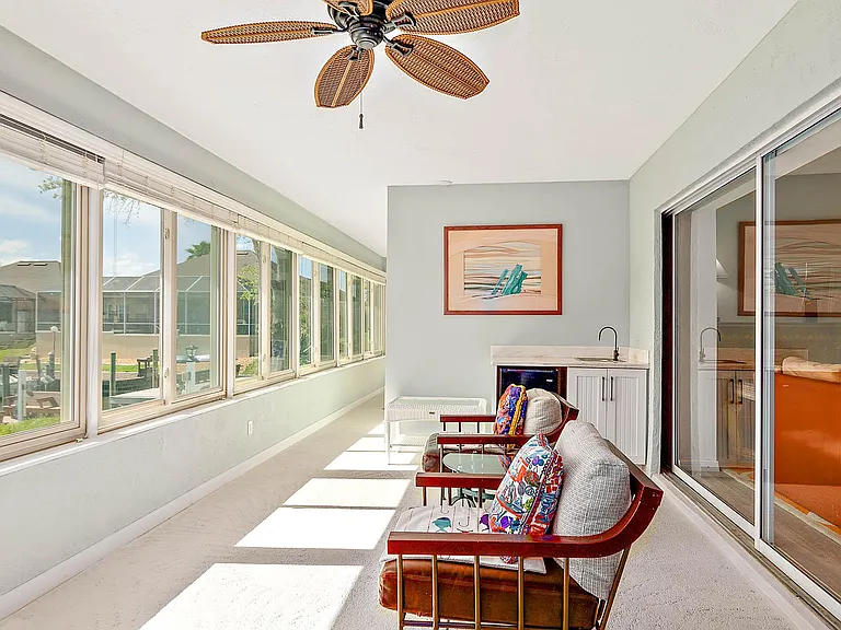 long patio over looking back yard and Canal connecting to Master bedroom , living room and kitchen