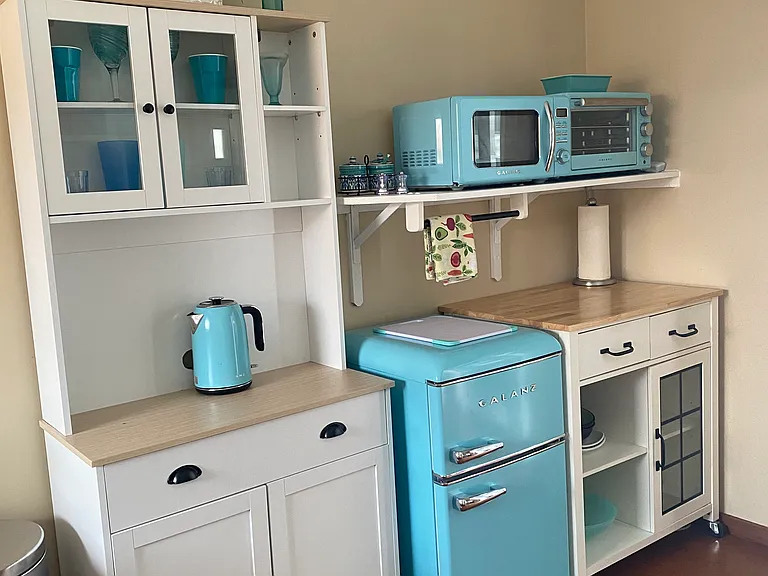Kitchenette with retro style mini fridge, microwave, and toaster oven. Crock pot available b
y request.