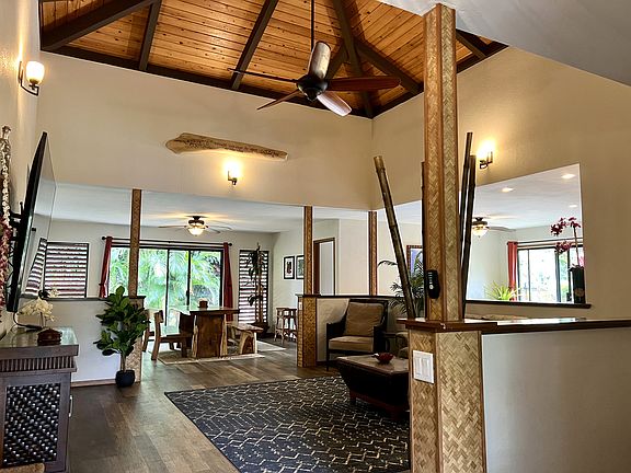 Open beamed, vaulted ceiling in the living room with open concept floorplan.