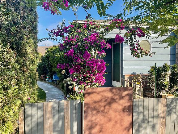 Front unit of a triplex with dedicated entrance and front private yard and large shared yard.