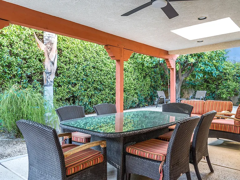 Outdoor dining table and nearby conversation area facing west.