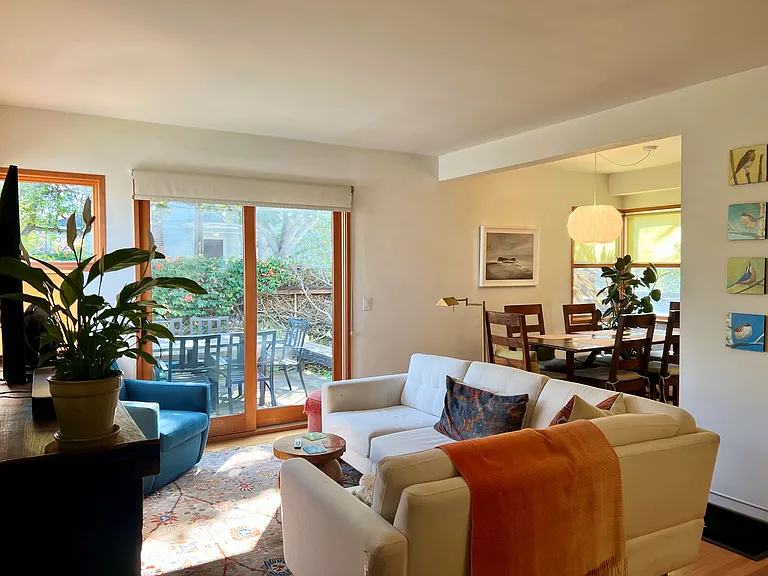 Living room opens to Dining; patio door opens to deck