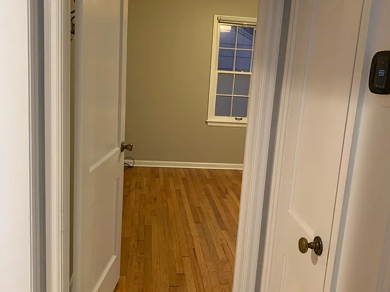 Upstairs hall view into primary bedroom, coat closet on right