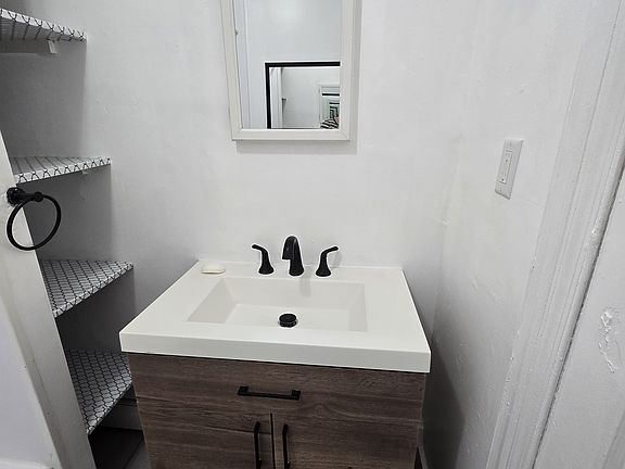 Bathroom vanity with storage shelves