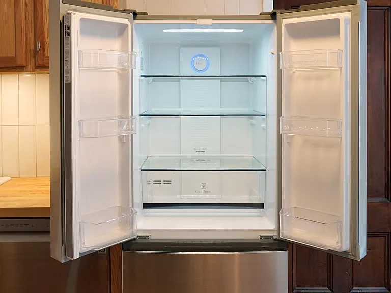 Very clean fridge with two freezer drawers