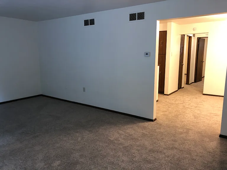 living room looking into dining room, hallway leads to bedrooms