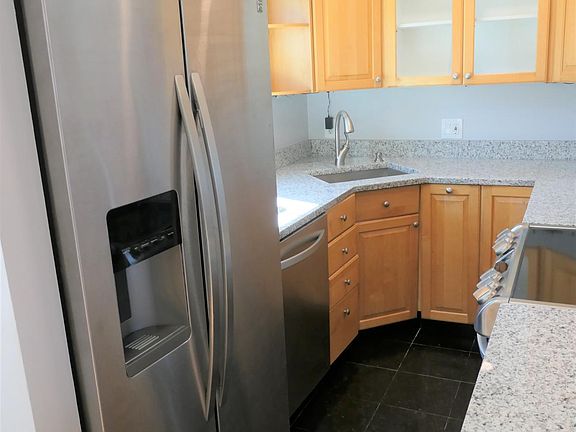Kitchen with appliances (stove, fridge & dishwasher)