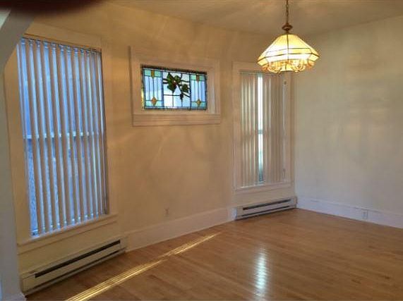 Dining room with stained glass window between two large wind