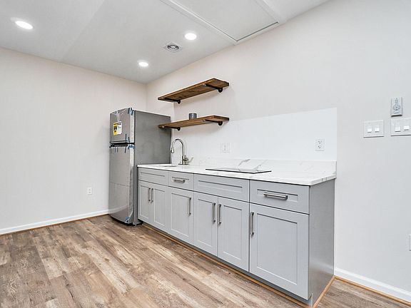 New kitchen with quartz countertops, stainless steel trim and modern accents.