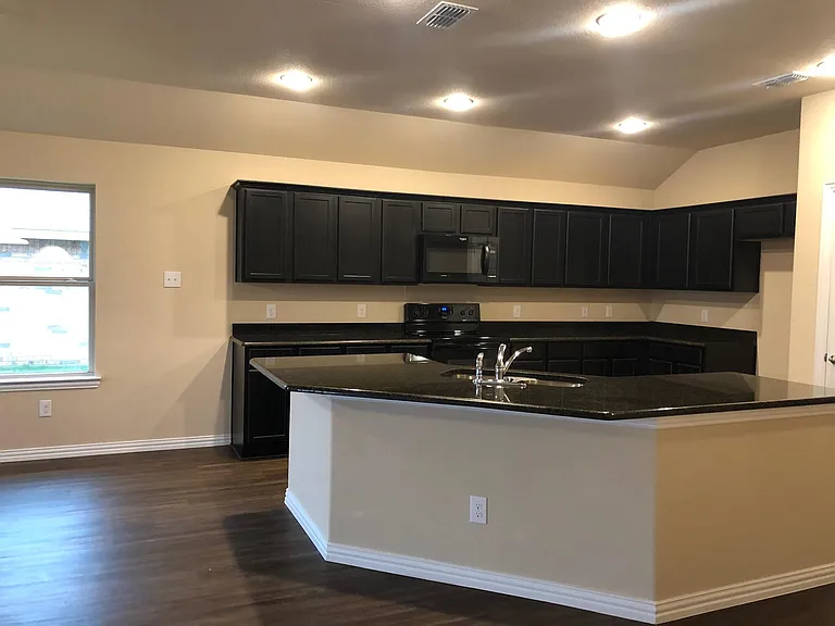 Huge kitchen with granite counter and modern cabinets