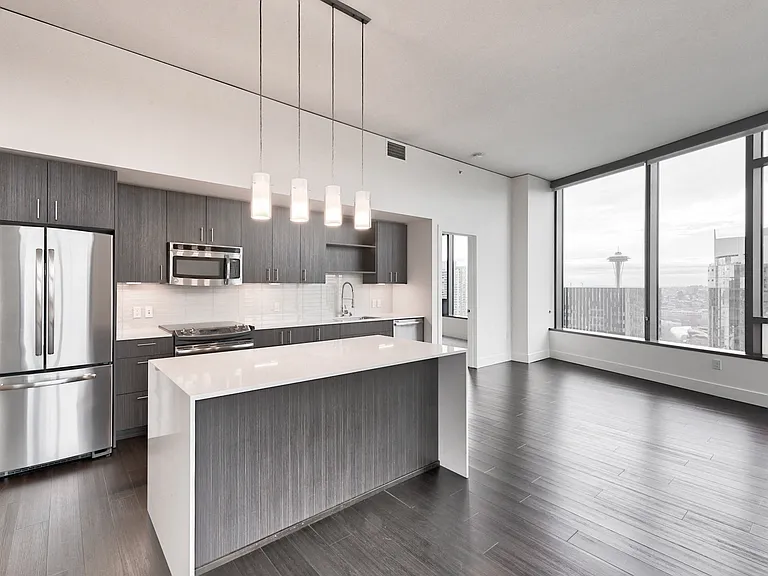 Enjoy entertaining on your waterfall quartz island with dramatic pendent lighting