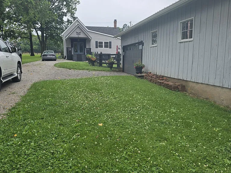 View from entrance from Charlie Lane, two car garage. Landlord's Workshop located on the property.