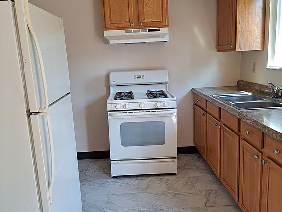Kitchen with gas range, refrigerator with glass shelves