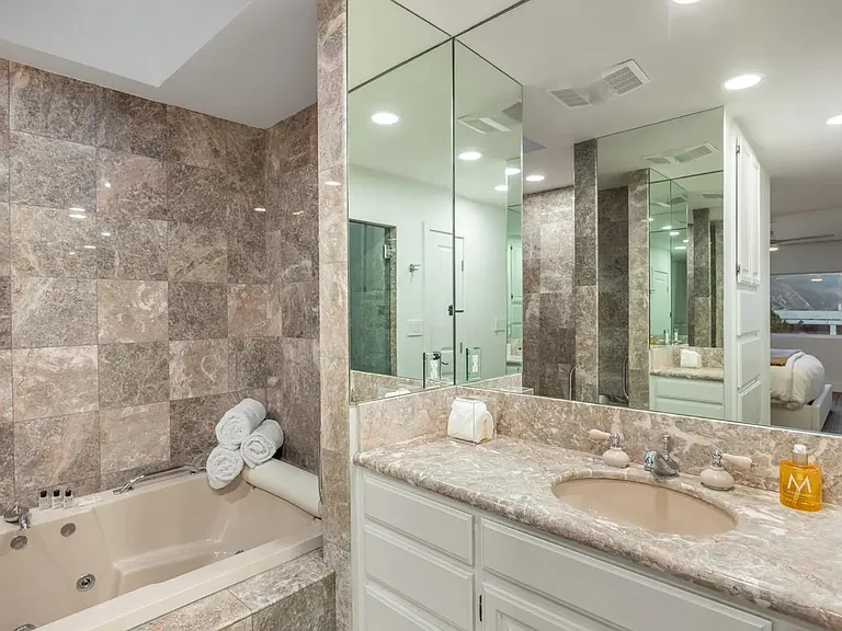 Experience opulence in the marble-tiled bathroom, boasting, fresh towels and premium amenities.