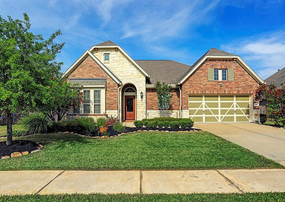 Welcome home...pristine landscaping and beautiful brick and stone exterior.
