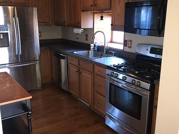 Kitchen with removable island, convection microwave, and gas stove. Window overlooking sink for beautiful views while doing dishes/cooking!