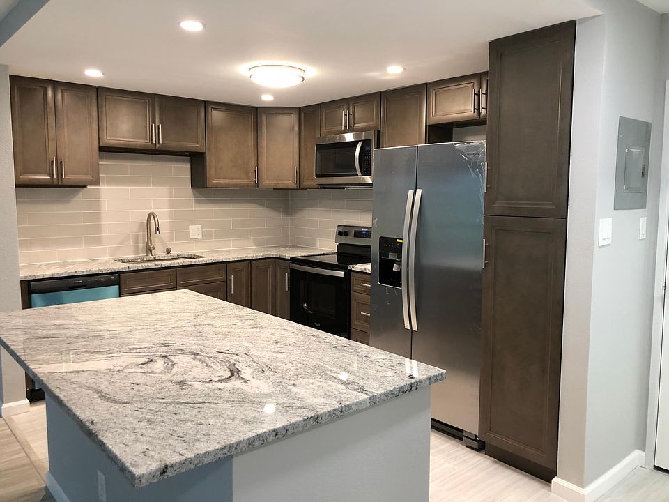 beautiful stainless steel appliance kitchen with soft close cabinets and tile back splash