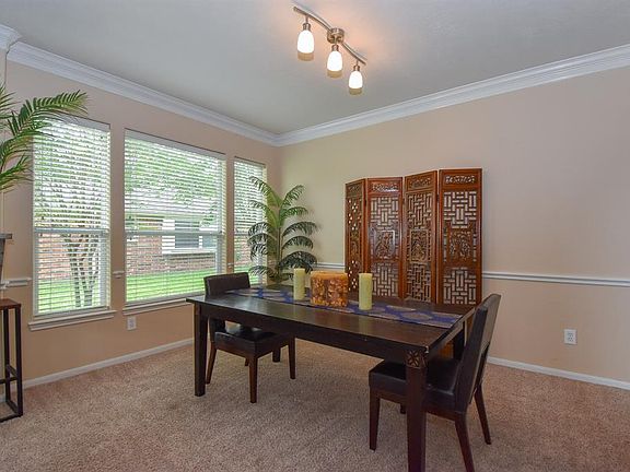 Entertaining guests or holidays dinners in the dining room can accommodate all of your friends and family with great views of the side yard and featuring crown molding, a chair rail and updated light fixture.
