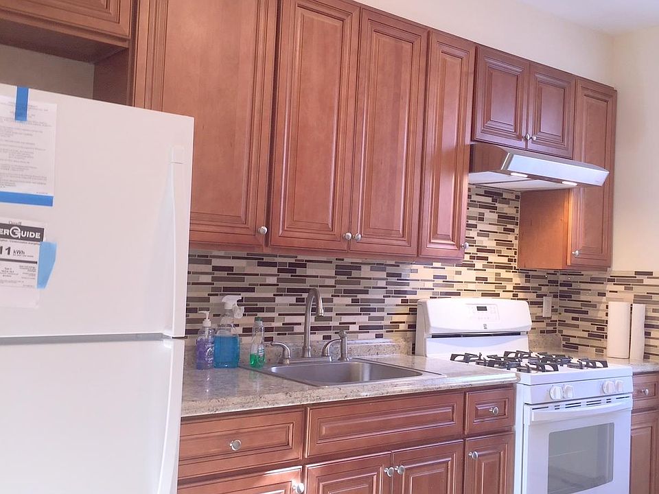 beautiful brand new kitchen ,granite counters, tile back splash on wall, new appliances and tile floor
