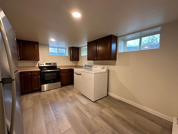 Kitchen with included washer/dryer and new stainless steel applicances