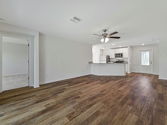 The open entertainment space includes the living room, dining room, and kitchen